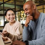 Office workers chat by a computer