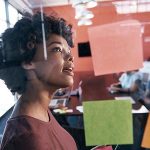 Woman looking at post-it notes