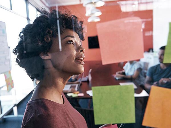 Woman looking at post-it notes