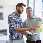 Two men working with post-it notes