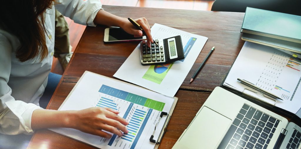 Woman calculating and working on forecasting mistakes