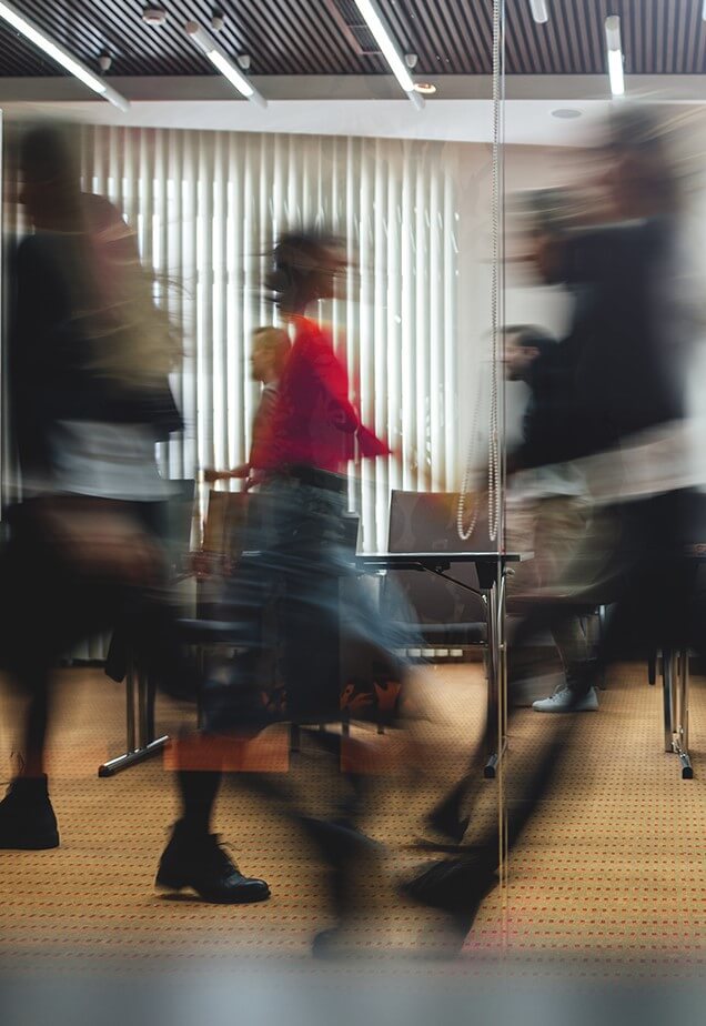 Businesspeople walking at modern office. Group of business employees at coworking center. Motion blur. Concept work process. Wide image